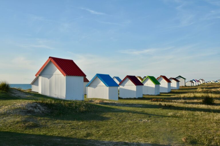 Colorful beach huts along the seascape in Cabanes de Gouville-sur-Mer, France. Perfect tourist attraction.